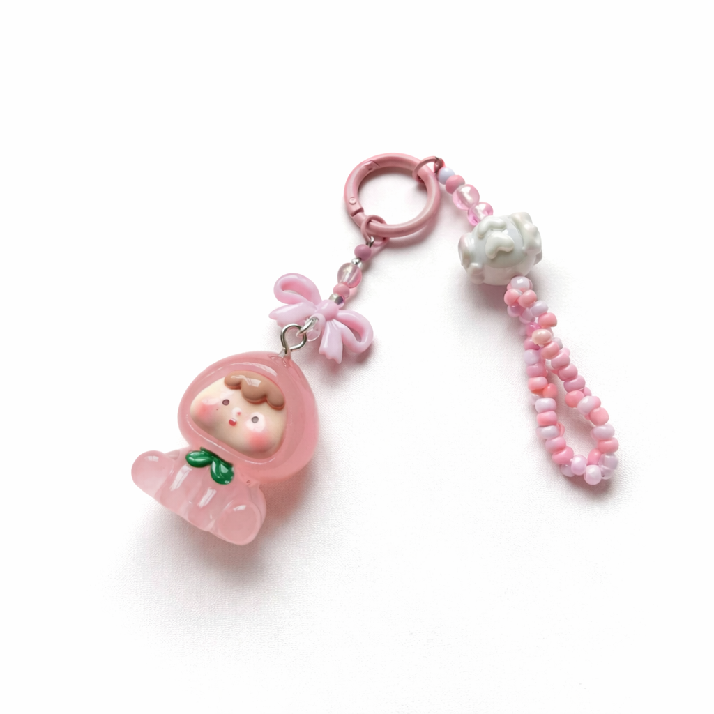 Pink Bow Baby Charm keychain with cartoon character on a white background